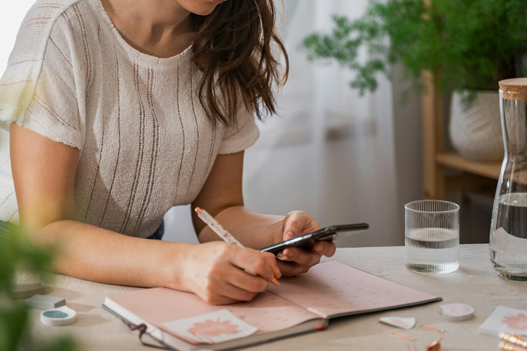 person writing in planner